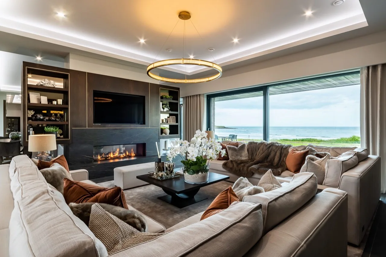 Sitting room with a fireplace and sea views at Camelot Waterford, Ardmore